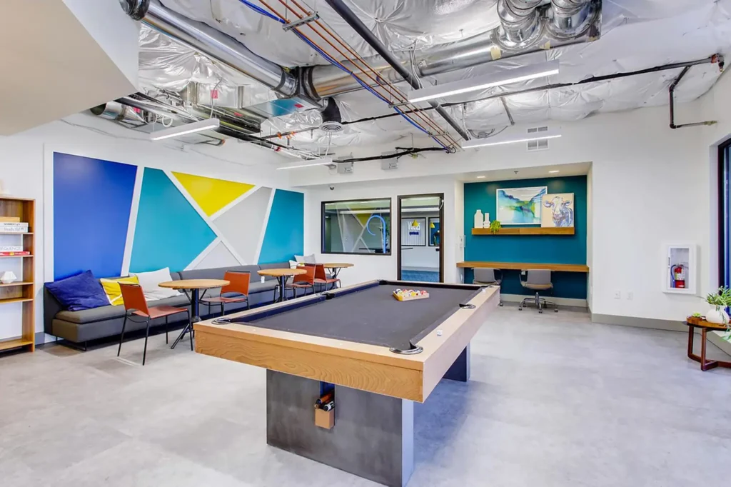 Clubhouse game room with billiards table and booth seating