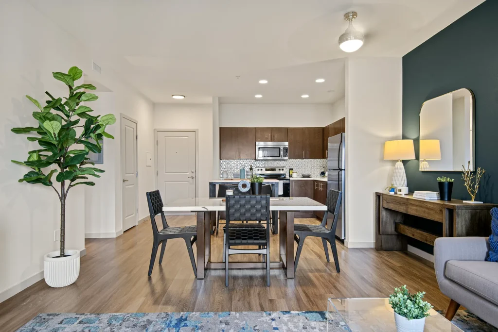 Staged living and dining room with view into open kitchen