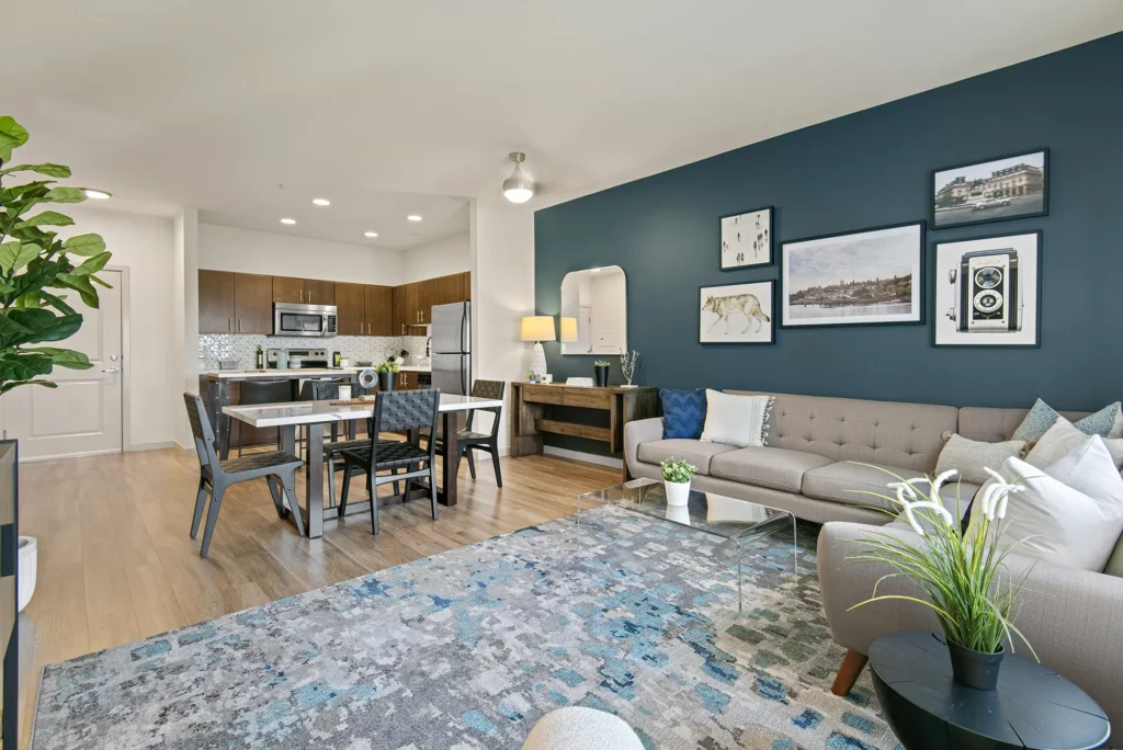 Staged living room and dining area looking into the open kitchen