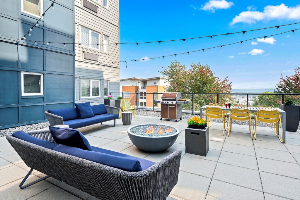 a large courtyard with outdoor furniture and a firepit