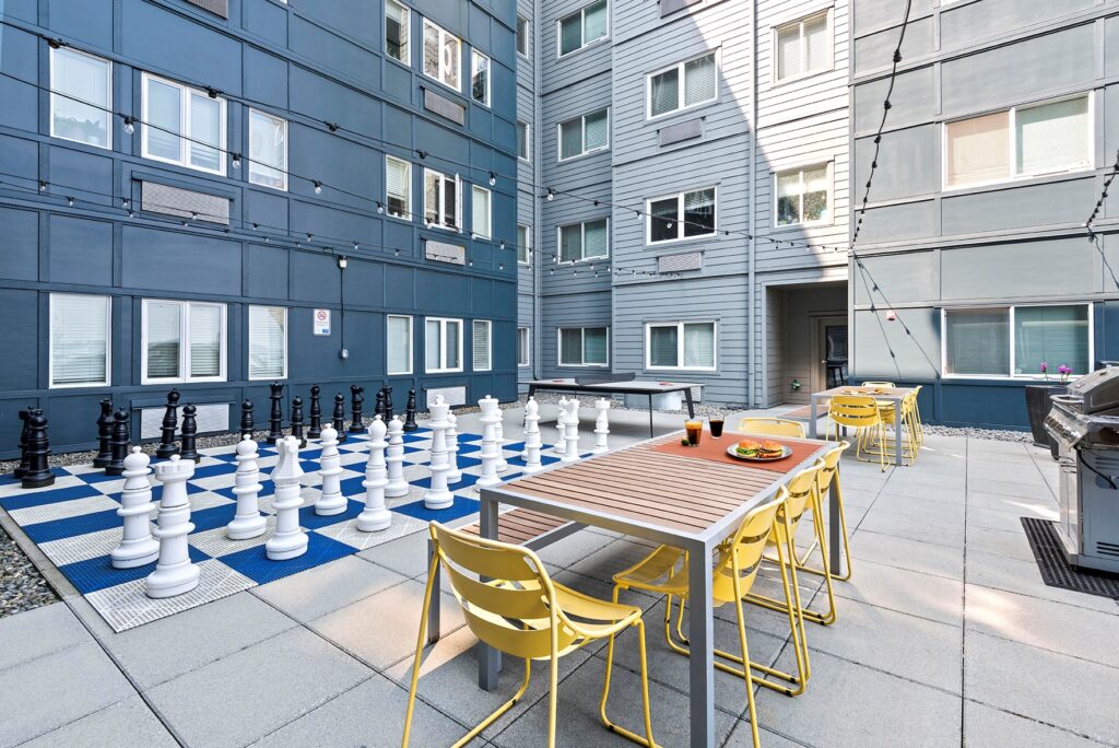 a courtyard with exterior furniture and outdoor games